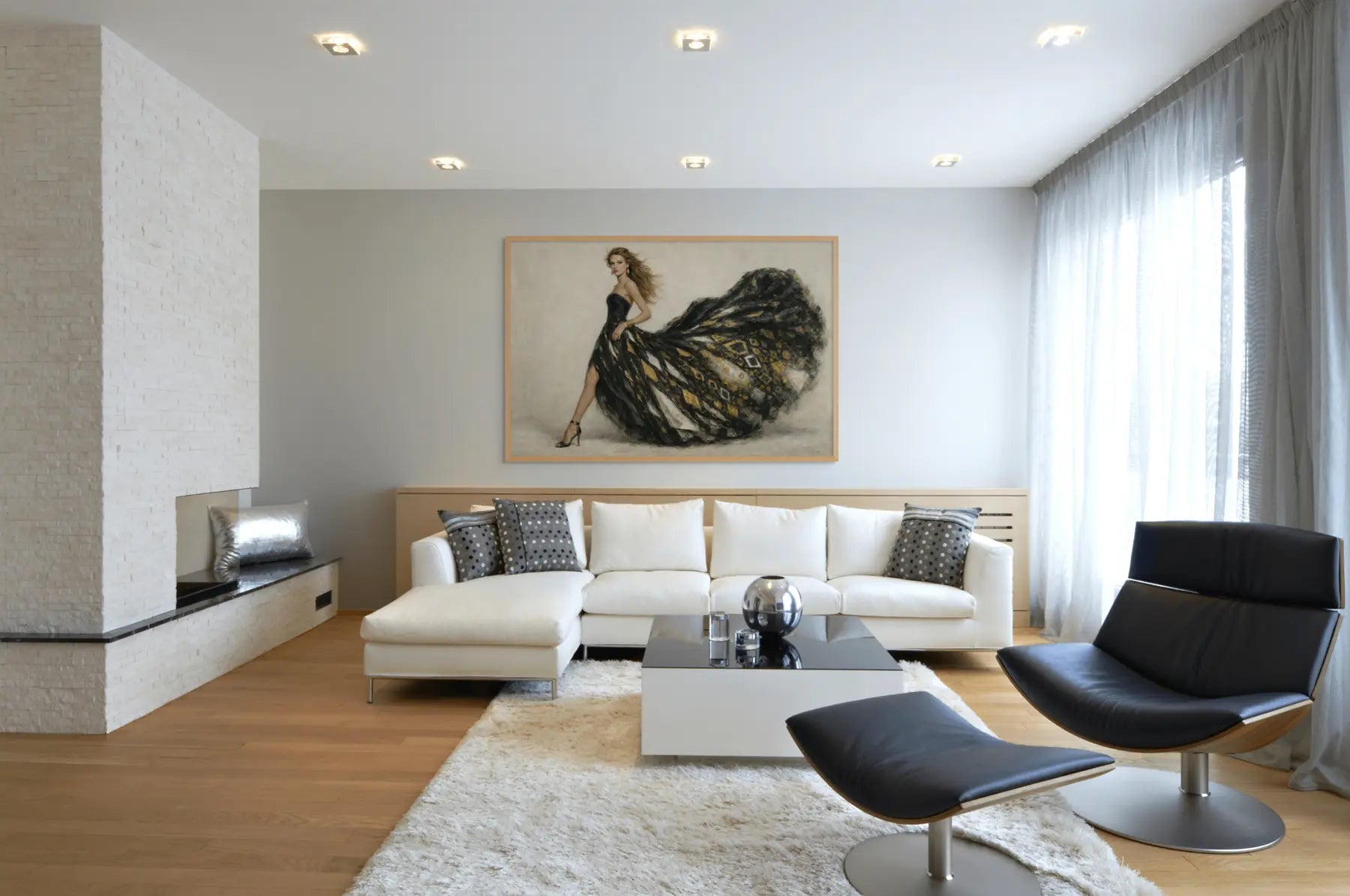 Gold leaf fashion wall art in black and gold displayed above sofa in a bright modern living room with neutral styling.
