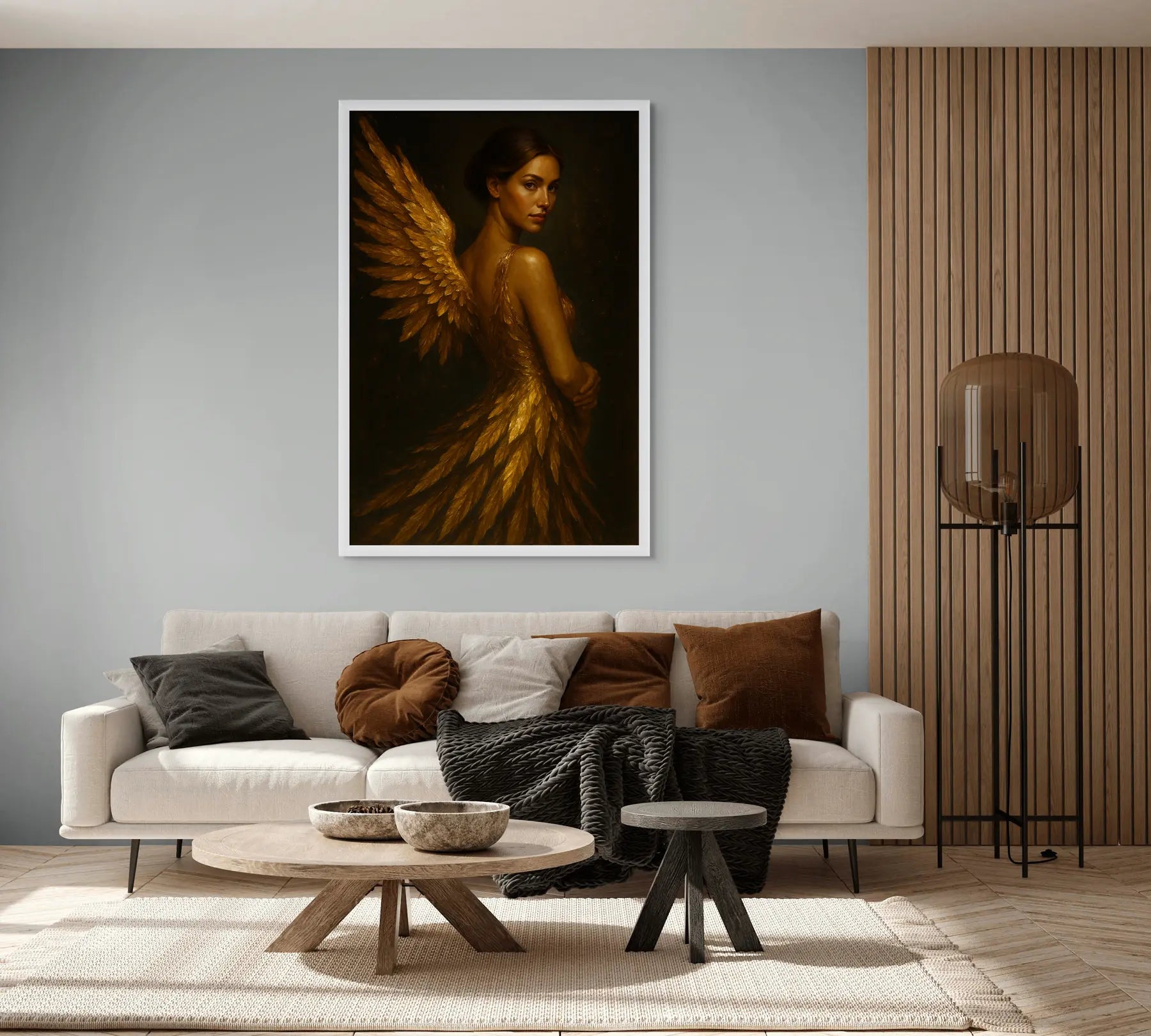 Luxury gold leaf portrait with wings displayed above a sofa in a modern neutral living room