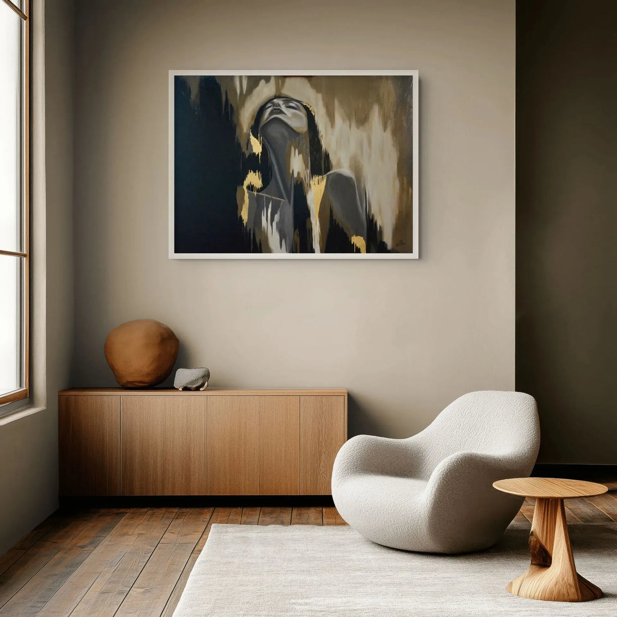 Release original mixed media artwork with 23K gold leaf displayed above a timber console in a contemporary neutral interior and displayed on a beige wall in a modern living room setting with a wooden sideboard, white armchair, and small wooden side table.
