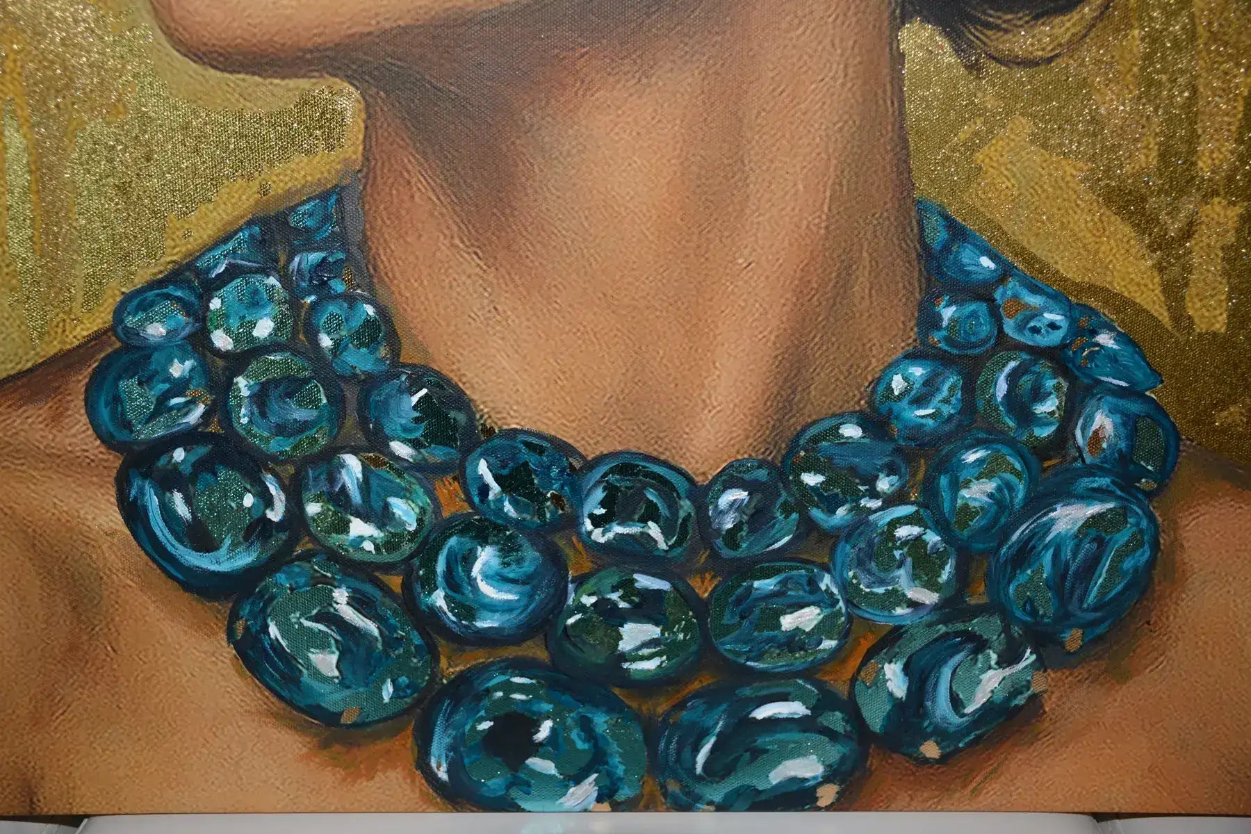 Close-up of blue beaded necklace of Azulina Glow original luxury painting against a luminous gold leaf foil background.