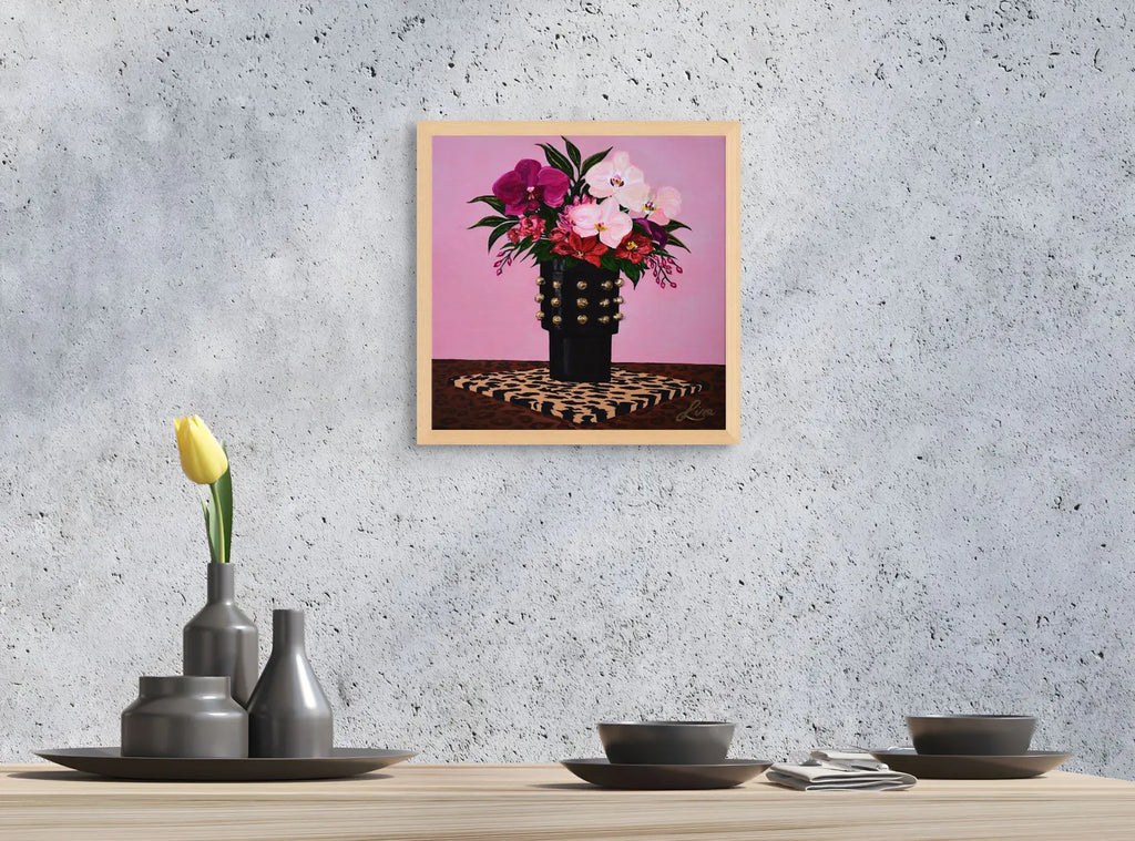 Oak framed original floral painting  and textured surface on a wall above a table with decorative items.