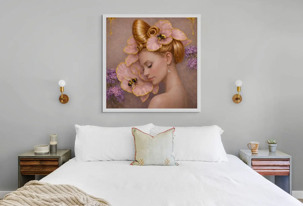 Luxury gold leaf portrait painting Gilded Honey III displayed in a white frame above a bed in a calm, contemporary bedroom interior.