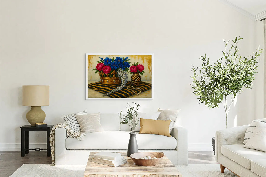 The Gilded Aviary luxury gold leaf painting displayed in a bright white living room, featuring a floral crown arrangement with blue and pink blooms, pearls, and a tiger-striped textile.