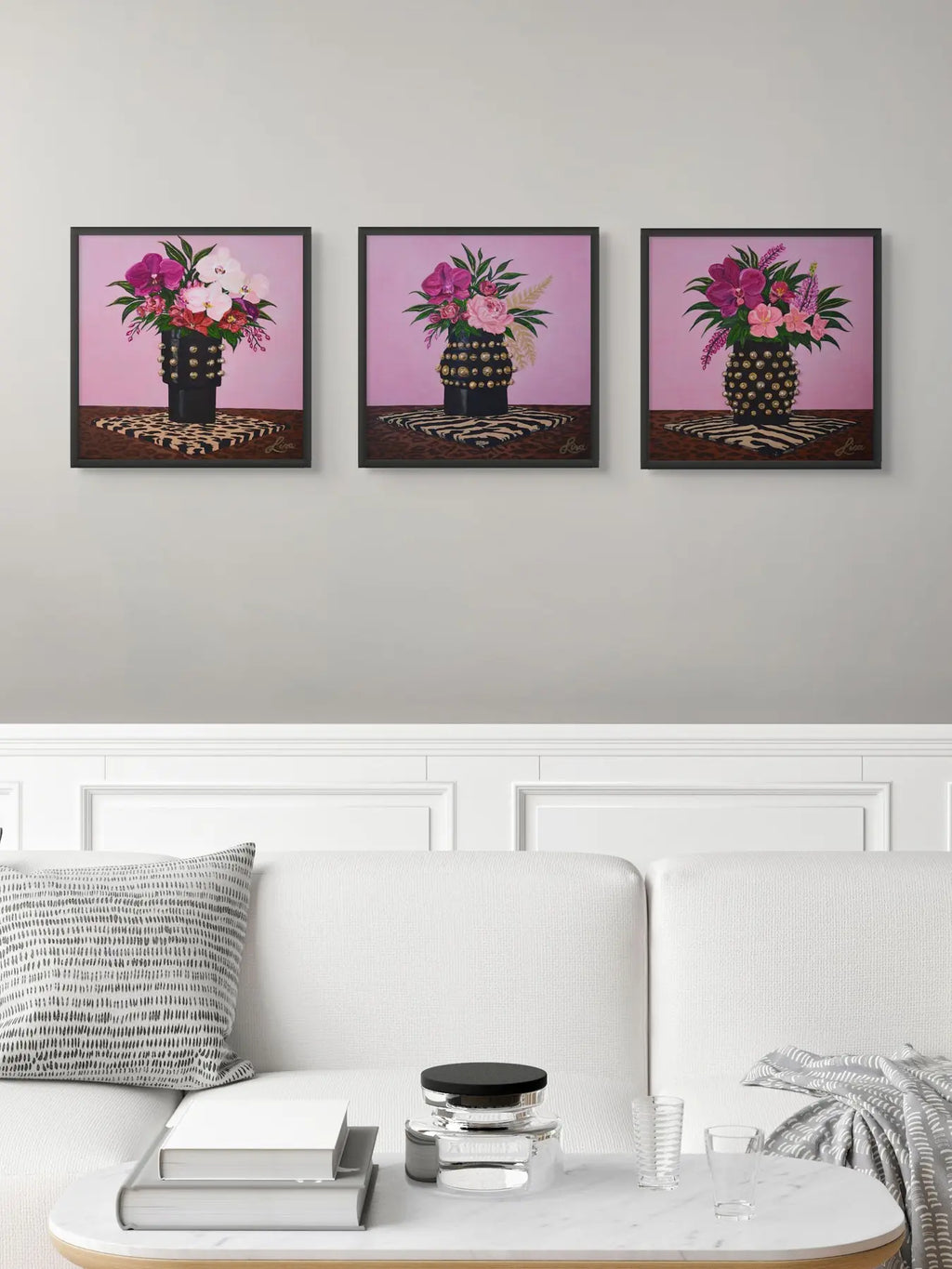 Original triptych artwork displayed in a black frame within a white contemporary living room.
