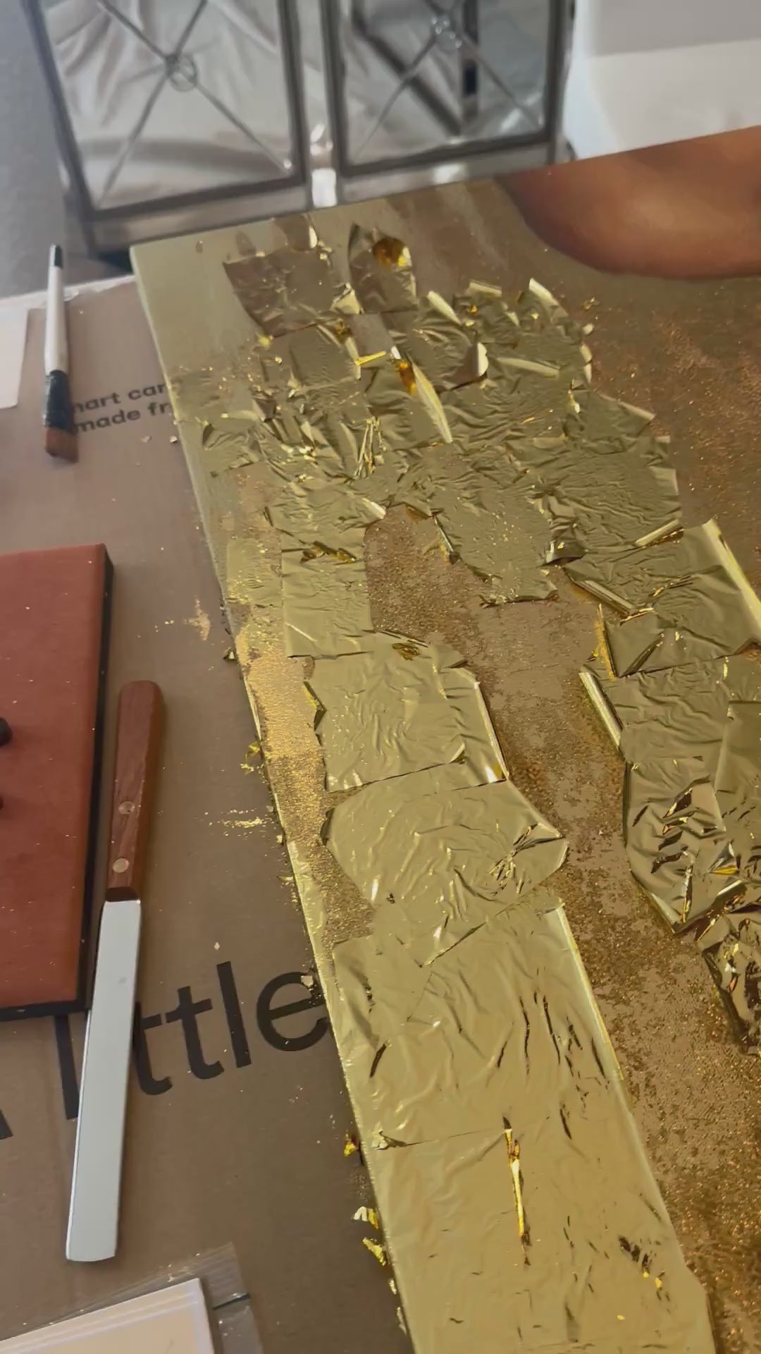 Gold leaf foil being applied to original painting by Luxe Wall Art by Lisa.